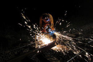 Sean Morris Sean Morris applies a high-speed spinning blade to cut the rail. Photo / Peter Calder