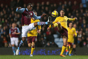 Arsenal's Mikel Arteta (right) and Villa's Christian Benteke battle for the ball in a game with few chances. Photo / AP