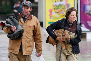Residents head for dry ground in St Asaph, North Wales. Photo / AP