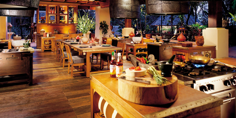 Whip up some traditional Thai cuisine in the well-equipped cooking school set high in the trees at the Four Seasons Resort in Chiang Mai. Photo / Supplied