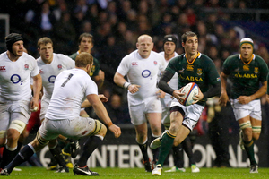 South Africa's Ruan Pienaar runs with the ball as England's captain Chris Robshaw, third left, moves across to attempt a tackle. Photo / AP