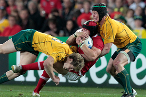 Leigh Halfpenny is tackled by Australia's James O'Connor (left) and Berrick Barnes during last year's Rugby World Cup bronze playoff. Photo / Natalie Slade