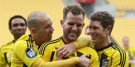 Jeremy Brockie, centre, is congratulated on scoring a goal by teammates Stein Huysegems and Tony Lochhead. Photo / AP