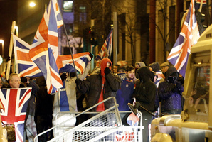 Loyalists confront Police Service of Northern Ireland officers as they try to force their way into Belfast City Hall when tempers flared about a week ago. Photo / AP
