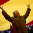 A man raises his hands as he holds a giant Spanish flag during a rally to celebrate of the 34th anniversary of the Spanish Constitution, in Madrid, Spain. Photo / AP