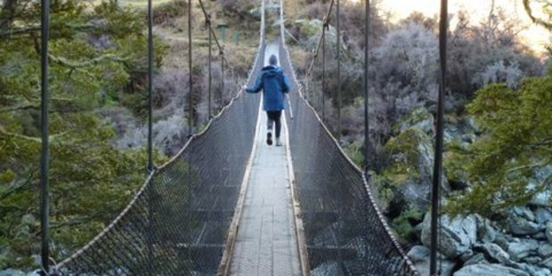 Justine Tyerman manages to cross the swing bridge over the Matukituki River. Photo / Chris Tyerman