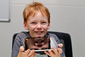 Eamon Rooney tests the Apple iPad. Photo / Michael Craig