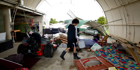 Cale Wood starts to clean up his shed on Ockleston Landing in Hobsonville after a tornado hit the area. Photo / Dean Purcell.