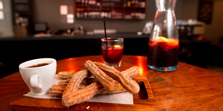 Churros with chocolate sauce and a jug of sangria at Basque Kitchen and Bar. Photo / Steven McNicholl
