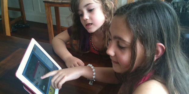 Micahel Gifford's granddaughters Sofia (l) and Julia playing the 7 Wonders of the World game. Photo / Supplied