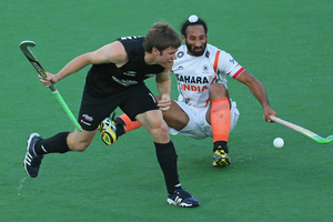 James Coughlan of New Zealand and Sardar Singh of India collide as they contest for the ball. Photo / Getty Images
