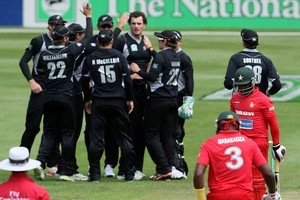 The Black Caps celebrate after taking an early Zimbabwe wicket. Photo / Getty Images