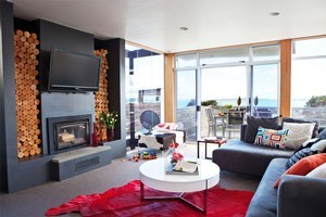 The use of bold colours in floor coverings and decor enlivens the Strachans' monochrome walls. Photo / Larnie Nicolson