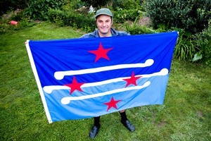Justin Newcombe with his self-designed New Zealand flag. Photo / Dean Purcell