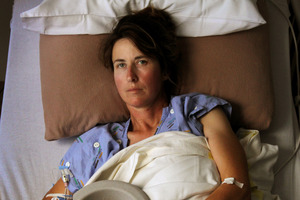 Amanda Austrin, pictured in Tauranga Hospital, still vomits every day - 18 months after her holiday. Photo / Alan Gibson