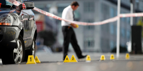 Police forensic teams investigate the crime scene on Pitt St, Auckland. Photo / Michael Craig