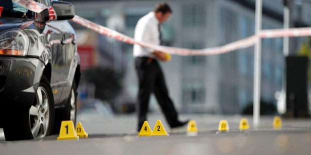 Police forensic teams investigate the crime scene on Pitt St, Auckland. Photo / Michael Craig