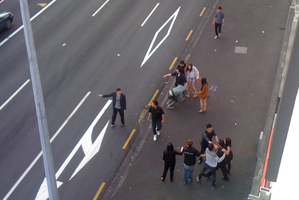 A man (on the far left) is holding what appears to be a knife outside a nightclub in central Auckland. Photo / Supplied