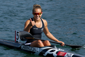 Smiling assassin Lisa Carrington gives the thumbs up after winning Olympic gold in the K1 200m canoe sprint. Photo / Brett Phibbs