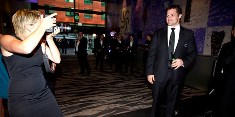 Richie McCaw stops to pose for Getty Images photographer Sandra Mu before the rugby awards ceremony in Auckland last night. Photo / Dean Purcell