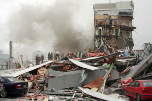 Police and volunteers work to rescue people trapped in the collapsed CTV building after the earthquake. Photo / Geoff Sloan