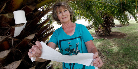 Caroline McLean who lives on Kensington Ave, amongst the palm trees that people use for a toilet stop. Photo / John Stone.