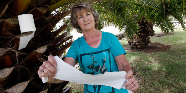 Caroline McLean who lives on Kensington Ave, amongst the palm trees that people use for a toilet stop. Photo / John Stone.