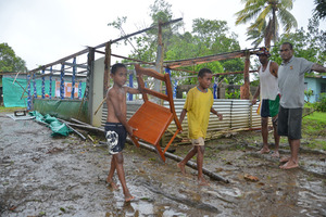 Twins Joen Soro and Mosikula Taitulo help remove the church furniture after the roof of Vusuya Methodist Church was blown off during the Tropical Cyclone Evans at Kuku. Photo / Jona Konataci/Fiji Sun