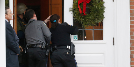 Emergency officals investigate a bomb threat at the St Rose of Lima Roman Catholic Church. Photo / AP