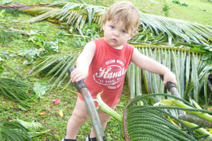 Elijah, 19 months, helps out with Cyclone Evan clean up in Alafua, Samoa. Photo / Vanessa/Supplied