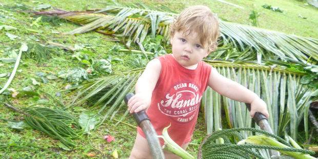 Elijah, 19 months, helps out with Cyclone Evan clean up in Alafua, Samoa. Photo / Vanessa/Supplied