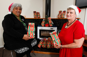 Te Whare Tiaki Wahine Refuge manager Caroline Herewini (left) and Women's Refuge chief executive Heather Henare preparing gifts for the families who will stay with them at Christmas. Photo / Mark Mitchell