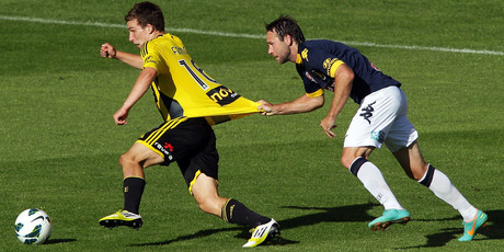Louis Fenton of the Phoenix is held back by Joshua Rose of the Mariners during the round 12 A-League match between the Wellington Phoenix and the Central Coast Mariners at Westpac Stadium. Photo / Getty Images