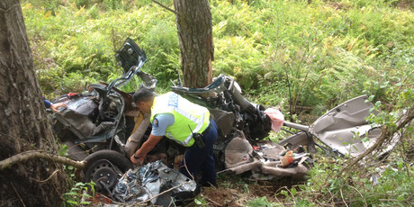 Police investigate the scene of a fatal crash where five were found dead. Photo / Christine Cornege