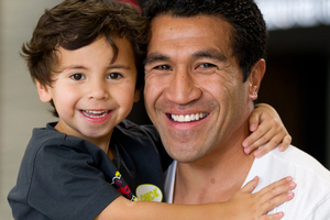 Mils Muliaina, with son Max in Auckland yesterday, is a star in Japan despite a string of losses. Photo / Sarah Ivey