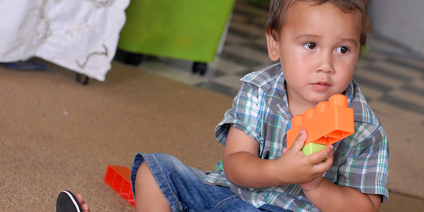 Ozyris Beeching, 2, at home in Edgecumbe a year on from when he was savaged by a dog after wandering next door with his new toy lawnmower. Photo / Lani Hepi