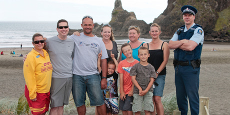 Jonathon Webber and Duncan Clarke, with Fiona Anderson (in blue) and others involved in the rescue of midnight skinnydippers who ignored warnings. Photo / Chris Loufte