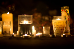 A message is seen on a candle outside the St. Rose of Lima Roman Catholic Church. Photo / AP