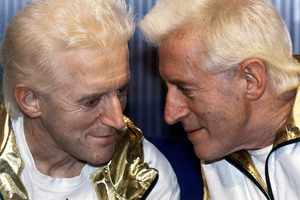 Jimmy Savile, right, posed with a wax work model at Madame Tussauds museum in London. Photo / AP