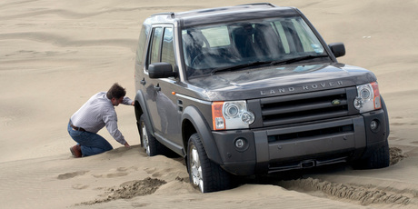 Dig out the sand around the wheels. A spade or shovel would be a lot better. Photo / Phil Hanson