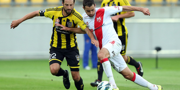 Andrew Durante of the Phoenix defends against Josip Tadic of the Heart during the round 13 A-League match between the Wellington Phoenix and the Melbourne Heart at Westpac Stadium. Photo / Getty Images