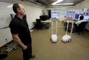 Bo Preising, Suitable Technologies' vice president of engineering talks to employees using a Beam robot. Photo / AP