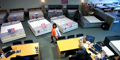 Two women worked together, one engaging a member of the staff at Bed Sale in Botany and the other walking out with blankets and lamps. Photo / Supplied
