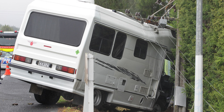 Two cars and a campervan collided on SH2 north of Katikati, causing powerlines to come down which cut power to may homes on Christmas Day. Photo / John Borren