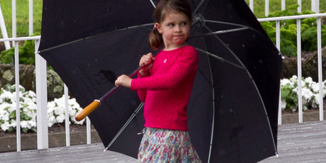 A little girl plays in the rain inbetween races at the Boxing Day Races at Ellerslie. Photo / Natalie Slade