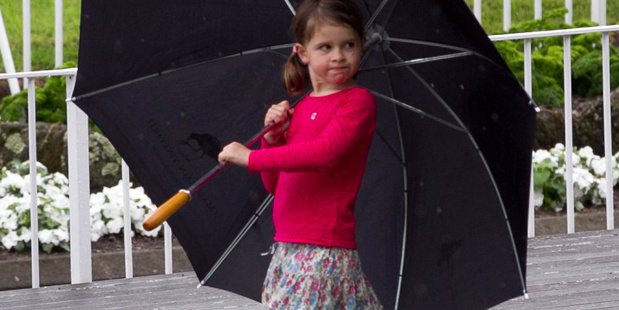 A little girl plays in the rain inbetween races at the Boxing Day Races at Ellerslie. Photo / Natalie Slade