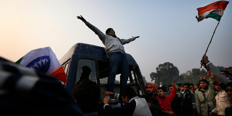 A protester climbs on the back of a police van during a violent demonstration near the India Gate against a gang rape and brutal beating of a 23-year-old student. Photo / AP