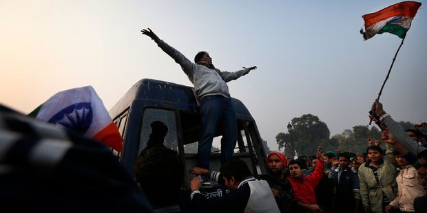 A protester climbs on the back of a police van during a violent demonstration near the India Gate against a gang rape and brutal beating of a 23-year-old student. Photo / AP