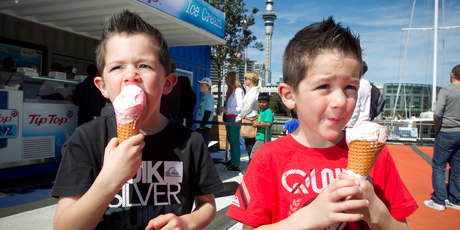 Six-year-old twins Blair (left) and Alex Gibson get stuck into icecreams at Auckland's Viaduct. Photo / Natalie Slade