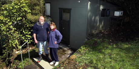 Angry new owners Gavin and Jenny Burgess at the Tremain brothers' former beach house. Photo / APN